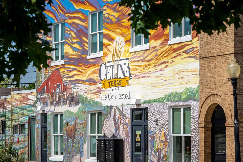 A vibrant mural adorns the side of a building, showcasing colorful designs and artistic expressions.